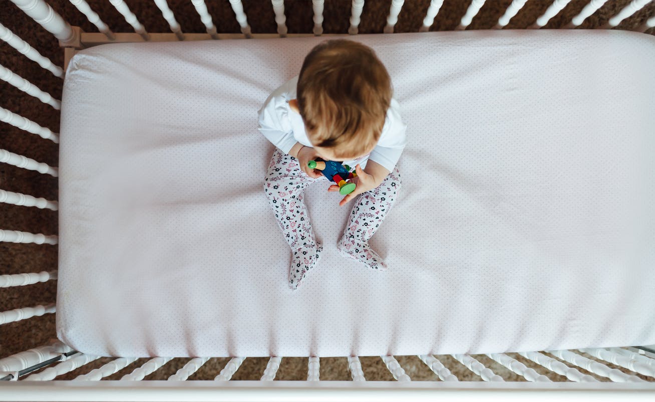 Lowering crib mattress to prevent child from climbing out Winnie
